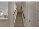 Modern staircase with dark wood railings and carpeted steps at 5608 Madrigal Way, Apollo Beach, FL 33572
