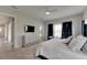 Main bedroom with large bed, dresser, and access to the bathroom at 5608 Madrigal Way, Apollo Beach, FL 33572