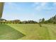 Spacious backyard with grassy area and trees at 5608 Madrigal Way, Apollo Beach, FL 33572