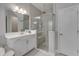 Bathroom with walk-in shower, white vanity, and a large mirror at 5608 Madrigal Way, Apollo Beach, FL 33572