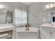 Modern bathroom with double vanity, large soaking tub, and separate shower at 5608 Madrigal Way, Apollo Beach, FL 33572