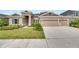 Two-story home with landscaped yard and two-car garage at 5608 Madrigal Way, Apollo Beach, FL 33572