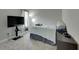 Spacious bedroom with a large TV, window with curtains and carpeted floor at 5608 Madrigal Way, Apollo Beach, FL 33572