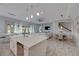 Open concept kitchen, island, and breakfast bar at 5608 Madrigal Way, Apollo Beach, FL 33572