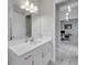 Modern bathroom with white cabinets, quartz countertop, and a view of an adjacent office at 5608 Madrigal Way, Apollo Beach, FL 33572