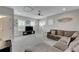 Spacious bonus room with large sectional sofa, TV, and carpeted floor at 5608 Madrigal Way, Apollo Beach, FL 33572