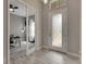 Open entryway with glass doors to an office and tile flooring at 5608 Madrigal Way, Apollo Beach, FL 33572