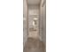 Hallway view of a spacious bathroom with a bathtub and separate shower at 5608 Madrigal Way, Apollo Beach, FL 33572