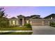 Two-story home with landscaped yard and two-car garage at 5608 Madrigal Way, Apollo Beach, FL 33572