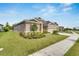 Two-story home with landscaped yard and two-car garage at 5608 Madrigal Way, Apollo Beach, FL 33572