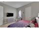 Bright bedroom with a full-size bed, dresser, and flat-screen TV at 5608 Madrigal Way, Apollo Beach, FL 33572