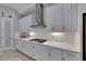 White kitchen with stainless steel appliances and gas cooktop at 5608 Madrigal Way, Apollo Beach, FL 33572