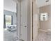 Hallway view of a bedroom and bathroom with light gray walls at 5608 Madrigal Way, Apollo Beach, FL 33572