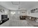 Spacious bonus room with large sectional sofa, TV, and carpeted floor at 5608 Madrigal Way, Apollo Beach, FL 33572