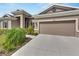 Two-car garage with taupe doors and neutral exterior at 5608 Madrigal Way, Apollo Beach, FL 33572