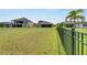 Backyard with fence and green lawn at 5608 Madrigal Way, Apollo Beach, FL 33572