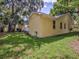 Yellow house exterior with a lush green lawn at 406 S Bayview Blvd # 1, Oldsmar, FL 34677