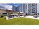 Community patio with pergola, tables, and artificial turf at 450 Knights Run Ave # 702, Tampa, FL 33602