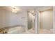 Modern bathroom with soaking tub, shower, and marble floors at 450 Knights Run Ave # 702, Tampa, FL 33602
