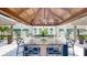 Outdoor grilling station under a covered pergola with seating for multiple guests at 450 Knights Run Ave # 702, Tampa, FL 33602