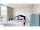Cozy bedroom with a comfy bed and teal dresser at 450 Knights Run Ave # 702, Tampa, FL 33602