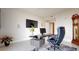 Modern home office with glass desk and built-in speakers at 450 Knights Run Ave # 702, Tampa, FL 33602