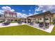 Relaxing community patio with pergola, tables, and artificial turf at 450 Knights Run Ave # 702, Tampa, FL 33602