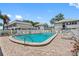 Community pool with lounge chairs and patio area at 1190 Rue Des Chateaux # 2A, South Pasadena, FL 33707