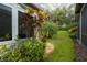 Landscaped backyard with lush greenery and mature plants at 15818 Cobble Mill Dr, Wimauma, FL 33598