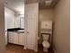 Bathroom with toilet, vanity, and storage cabinet at 501 Knights Run Ave # 1327, Tampa, FL 33602