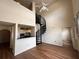 Open living room with spiral staircase, high ceilings, and wood-look floors at 501 Knights Run Ave # 1327, Tampa, FL 33602