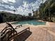 Inviting community pool with lounge chairs and a surrounding patio at 501 Knights Run Ave # 1327, Tampa, FL 33602
