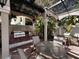 Community grilling area with brick grills and tables under a pergola at 501 Knights Run Ave # 1327, Tampa, FL 33602