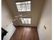 High-ceilinged living area with large windows and wood-look floors at 501 Knights Run Ave # 1327, Tampa, FL 33602