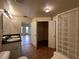 Bathroom with double vanity, glass block shower, and linen closet at 501 Knights Run Ave # 1327, Tampa, FL 33602