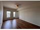 Bedroom with wood-look floors, large windows, and private balcony access at 501 Knights Run Ave # 1327, Tampa, FL 33602