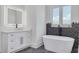 Elegant bathroom featuring a soaking tub, modern vanity, and a walk-in shower at 6012 Kipps Colony E Dr, Gulfport, FL 33707