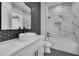 Modern bathroom with white vanity, marble tile, and geometric accents at 6012 Kipps Colony E Dr, Gulfport, FL 33707