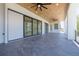 Spacious covered patio with tile flooring, ceiling fans, and sliding glass doors at 6012 Kipps Colony E Dr, Gulfport, FL 33707