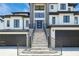 Modern home's entryway features a gray stone staircase with sleek black railings at 6012 Kipps Colony E Dr, Gulfport, FL 33707