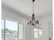 Elegant dining room with chandelier and large windows offering natural light at 6012 Kipps Colony E Dr, Gulfport, FL 33707