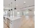 Open concept kitchen with white cabinets, large island, and breakfast bar at 6012 Kipps Colony E Dr, Gulfport, FL 33707