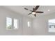Bright bedroom with ceiling fan, hardwood floors, and multiple windows at 6012 Kipps Colony E Dr, Gulfport, FL 33707
