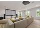 Home theater room with sectional sofa, large screen, and surround sound at 6012 Kipps Colony E Dr, Gulfport, FL 33707