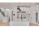 Open concept kitchen with white cabinets, large island, and stainless steel appliances at 6012 Kipps Colony E Dr, Gulfport, FL 33707