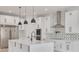 Modern kitchen featuring white cabinets, stainless steel appliances, and a large island at 6012 Kipps Colony E Dr, Gulfport, FL 33707