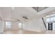 Open living space with high ceilings, hardwood floors, and modern staircase at 6012 Kipps Colony E Dr, Gulfport, FL 33707
