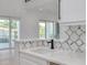 Modern kitchen with white quartz countertop and geometric backsplash at 6012 Kipps Colony E Dr, Gulfport, FL 33707