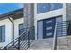 Stylish modern staircase with a sleek black metal railing at 6012 Kipps Colony E Dr, Gulfport, FL 33707