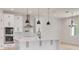 Modern kitchen featuring white cabinetry, quartz countertops, and stainless steel appliances at 6012 Kipps Colony E Dr, Gulfport, FL 33707